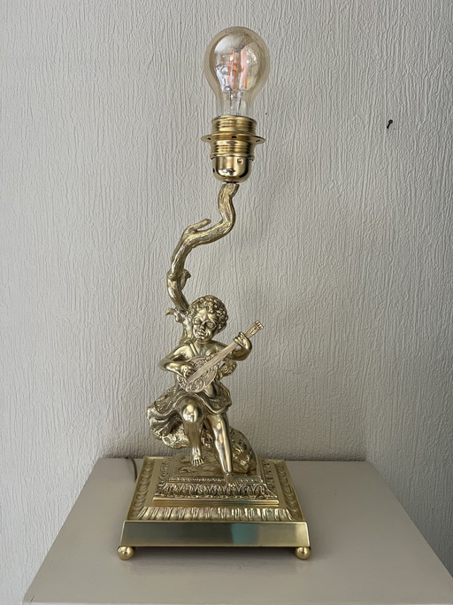 Bronze table lamp depicting a cherub playing the guitar