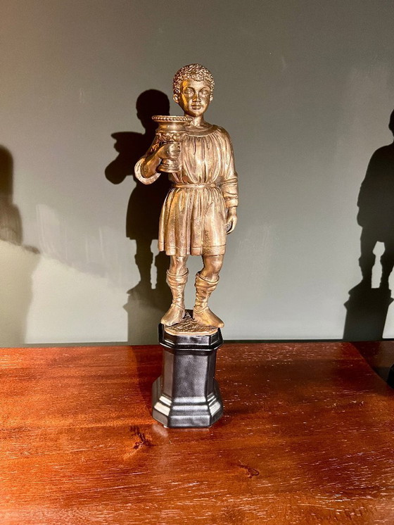 Image 1 of Rarität! Kerzenständer mit der Abbildung eines orientalischen Jünglings aus Messing auf schwarzem Porzellanfuß, 20. Jahrhundert 