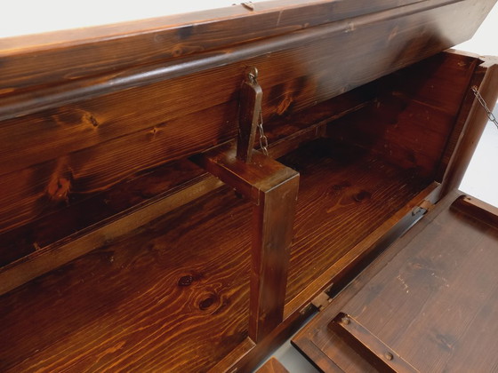 Image 1 of Een laag, brutalistisch dressoir van Georges Robert, gemaakt van donker grenenhout, uit de jaren 50/60.