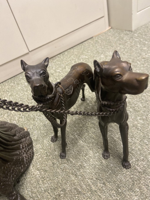 Metal Statue Of Woman With Two Leashed Dogs