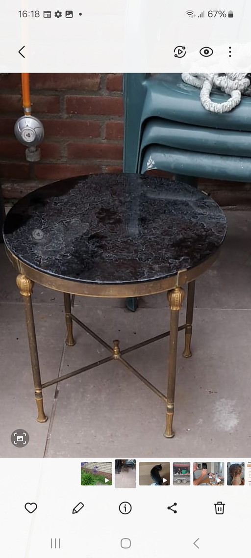 Antique brass so called coffee table with black marbled glass top