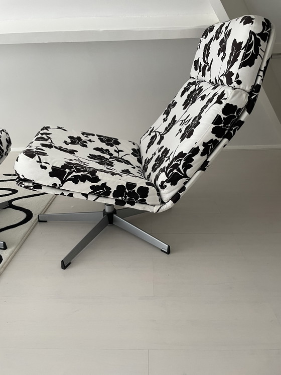 Image 1 of Black and white floral armchair with footstool