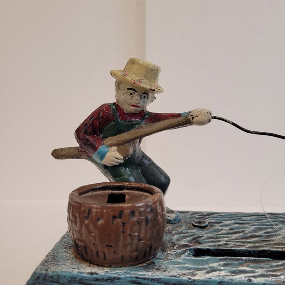 Image 1 of "Fisherman" piggy bank with fishing mechanism, cast iron, 1950s - USA.