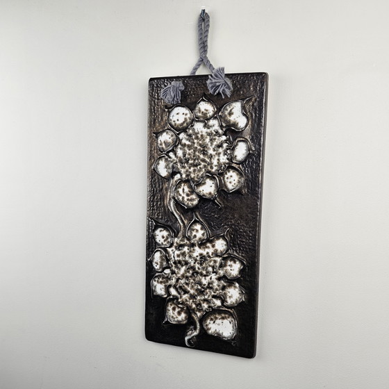 Image 1 of Una targa murale della Germania Ovest, realizzata da Carstens. La targa è rettangolare e raffigura fiori bianchi.