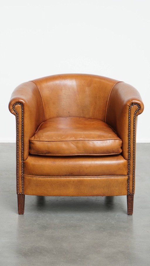 In good condition sheep leather club chair