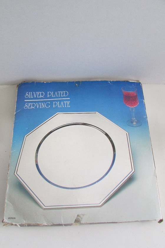 Image 1 of Dos platos base plateados en su embalaje original.