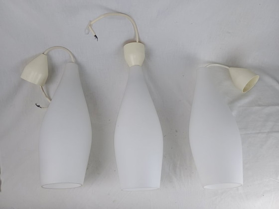 Image 1 of Elegant and timeless, this set of three original Holmegaard glass pendant lamps