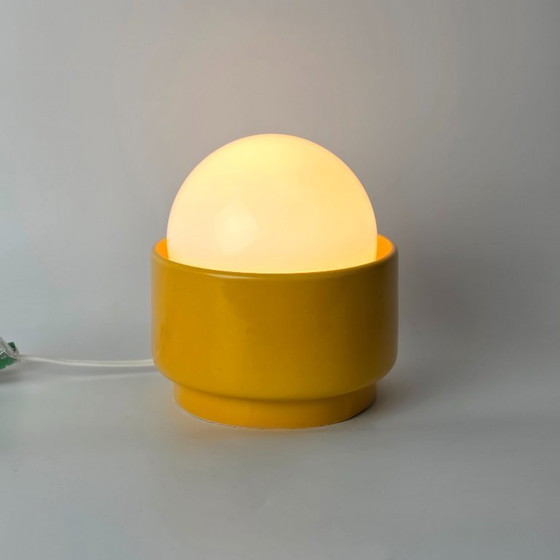 Image 1 of Vintage German ceramic lamp with a glass globe shade. Can be used as a wall lamp, table lamp, or sconce. Yellow. 70s / retro