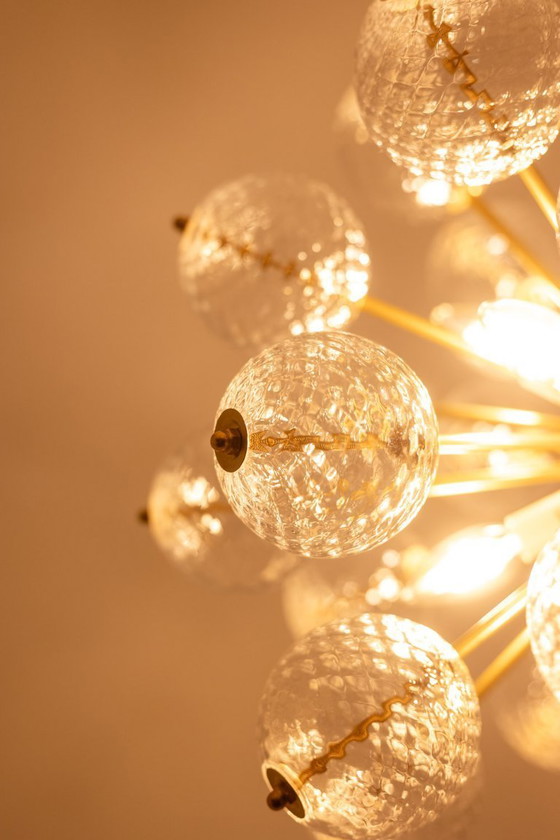 Image 1 of Kamenicky Senov, editor. Pair of brass and glass chandeliers. Circa 1970