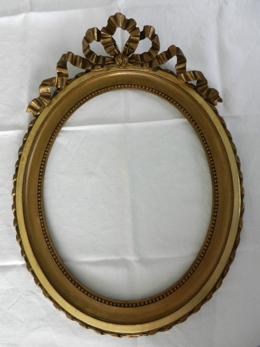 Cornice ovale antica in legno dorato, nodo stile Luigi XVI