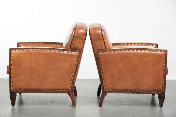 Image 1 of 2 x Prachtige schapenleren Art Deco fauteuil met mooi houtsnijwerk en zwarte biezen