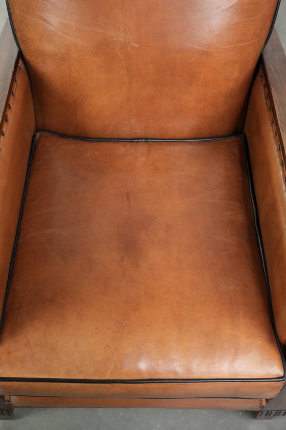 Image 1 of Unieke schapenleren art Deco fauteuil met mooi houtsnijwerk en zwarte biezen