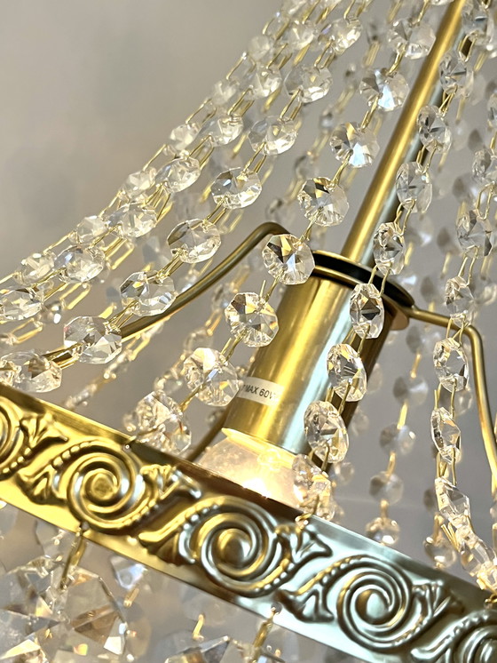 Image 1 of Lampadario con struttura in oro e 4 luci a forma di borsa di cristallo