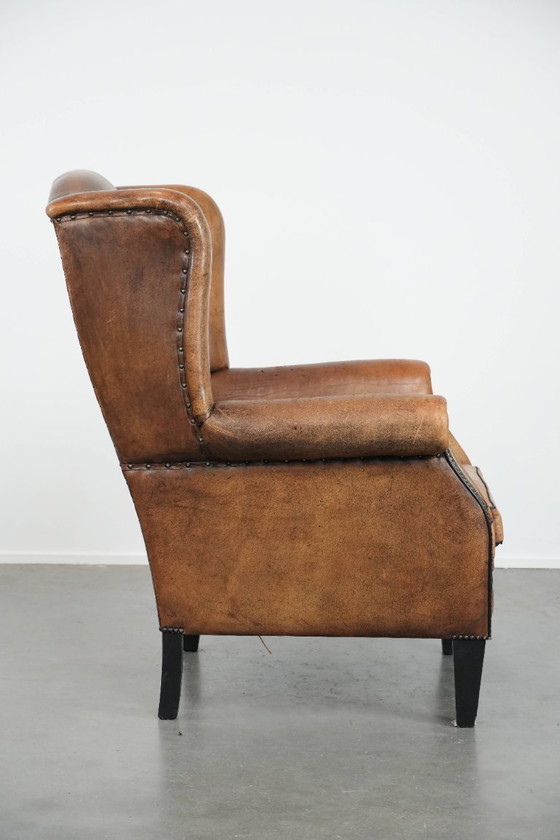 Image 1 of Sheepskin wing chair with a characterful appearance