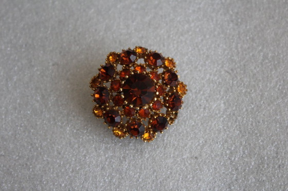 Image 1 of Vintage costume jewelry brooch with amber rhinestones, marked SPHINX