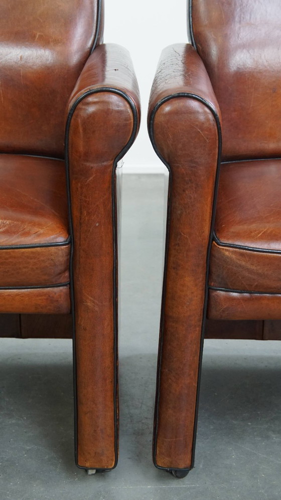 Image 1 of 6 x Vintage sheepskin dining chair with black piping on wheels