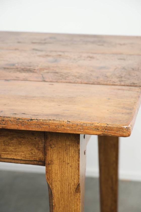 Image 1 of Large, relatively narrow antique French farmhouse dining table made of pine from the early 19th century with a beautiful patina.