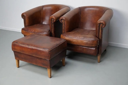 Vintage Nederlandse leren clubfauteuils in cognackleur, set van 2 met voetenbank