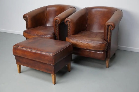 Image 1 of Vintage Nederlandse leren clubfauteuils in cognackleur, set van 2 met voetenbank