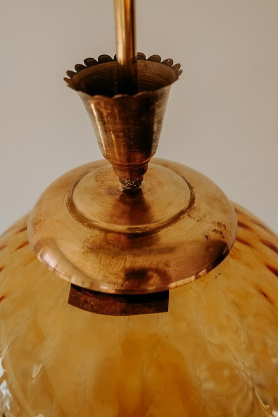 Brass Pendant Lamp with Round Orange Glass Shade and Swirl Structure (photo 6 of 8)