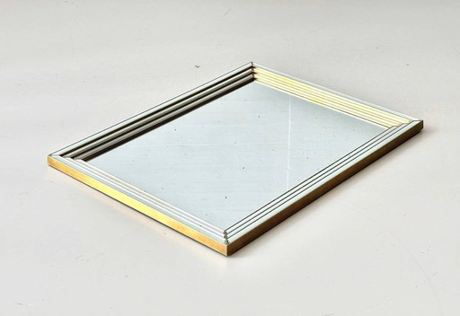 Wall mirror framed with faceted mirror glass