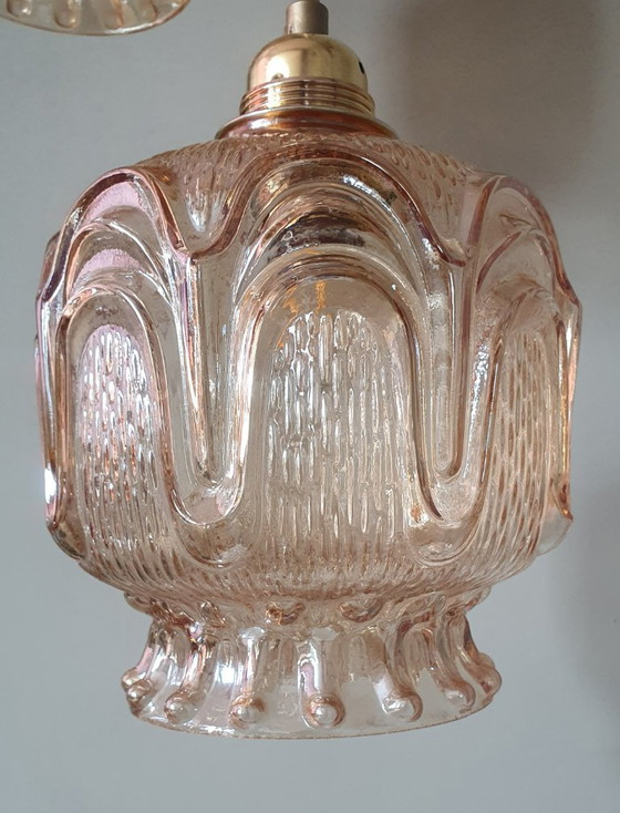 Image 1 of Set of 2 Vintage textured rose / amber tinted pendant lamps - mid-century design.