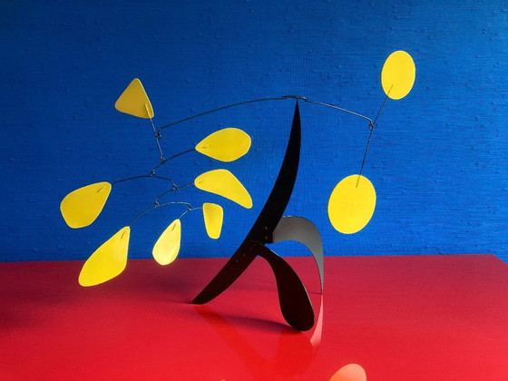 Image 1 of Black stabile with 9 yellow discs and leaves