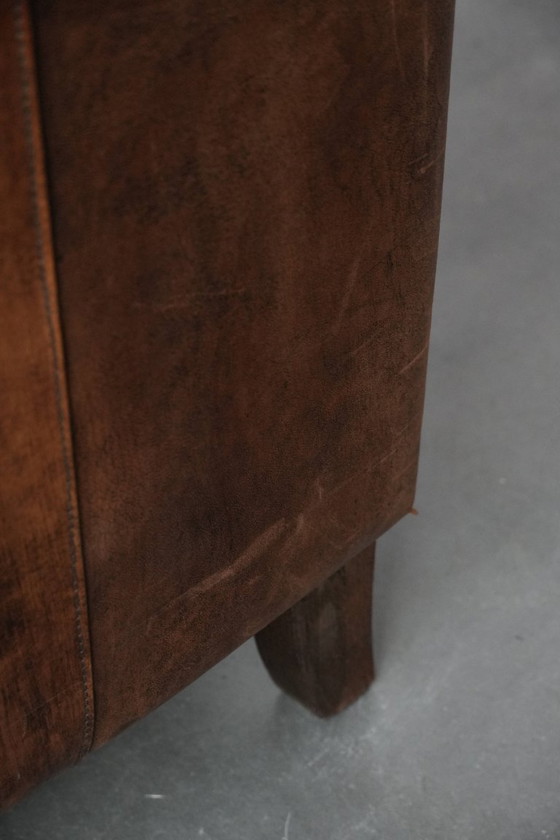 Image 1 of 2 x Vintage sheepskin armchair with warm colours and a characterful appearance