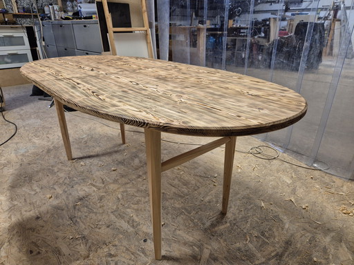 Oval dining table with burnt wood top