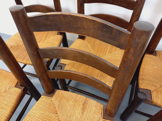 Image 1 of Set van 6 vintage brutalistische stoelen van Georges Robert, gemaakt van hout en stro, uit de jaren 50 en 60.