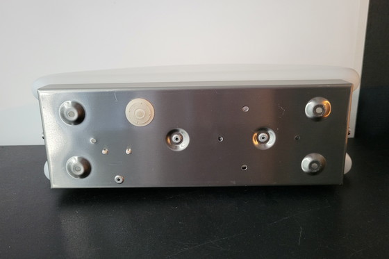 Image 1 of 3 RAAK (bathroom) wall lamps with opaline glass shade and stainless steel frame.