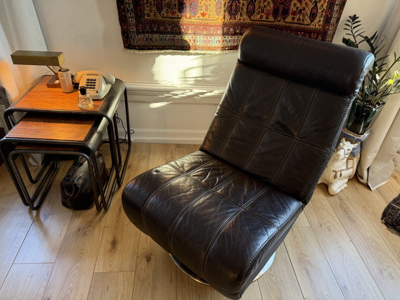Image 1 of Dark brown vintage leather lounge armchair – timeless luxury and character