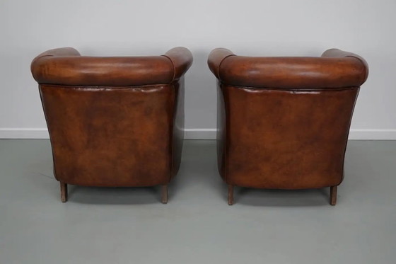 Image 1 of Vintage Nederlandse leren clubfauteuils in cognackleur, set van 2 met voetenbank