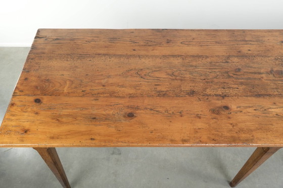 Image 1 of Large, relatively narrow antique French farmhouse dining table made of pine from the early 19th century with a beautiful patina.