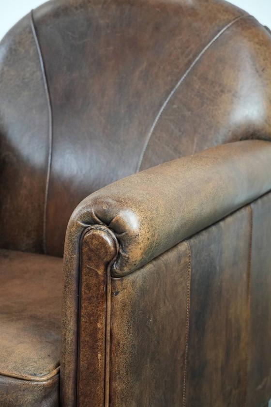 Image 1 of 2 x Vintage sheepskin armchair with warm colours and a characterful appearance
