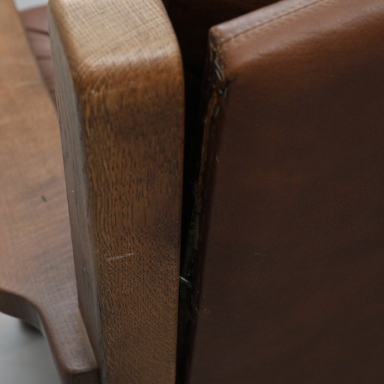 Image 1 of A vintage brown three-piece sofa set in leather with wooden armrests and turned legs, comprising a 1-seater, 2-seater and 3-seat