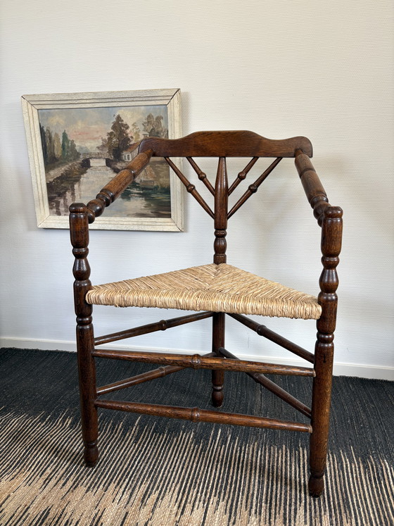 Image 1 of  Vintage Antiek 20ste eeuw eiken hoekstoel met biezen zitting h85cm