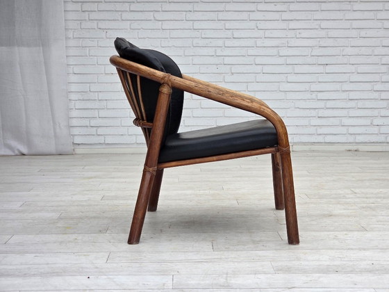 Image 1 of 1970s, Danish armchair, rattan, black artificial leather.