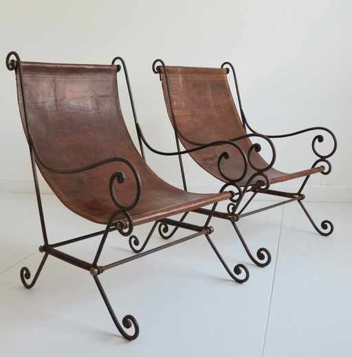 Pair of wrought iron and vintage leather armchairs