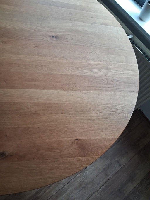 Light round dining table