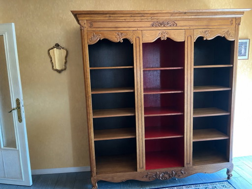 Antique vintage wooden bookcase with carved floral moldings