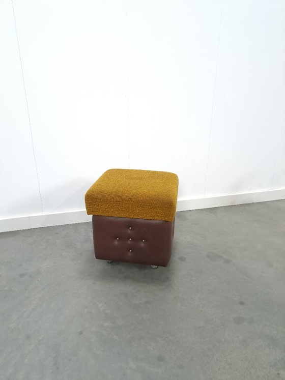 Image 1 of Ottoman with lid on chrome wheels