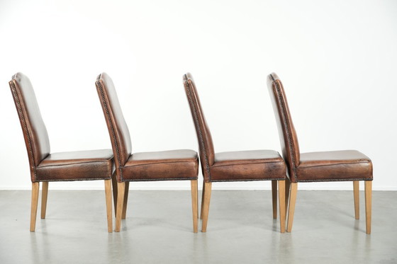 Image 1 of 4 x Vintage eetkamerstoel gemaakt van schapenleer met een hoge rug