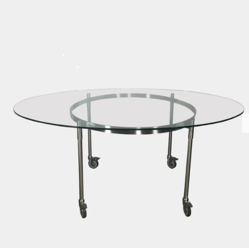 Mesa de comedor Diade Tio: redonda, con patas de cristal y acero inoxidable.