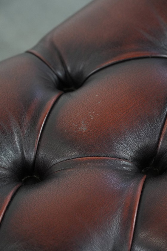 Image 1 of Dark brown Chesterfield footstool made of cowhide