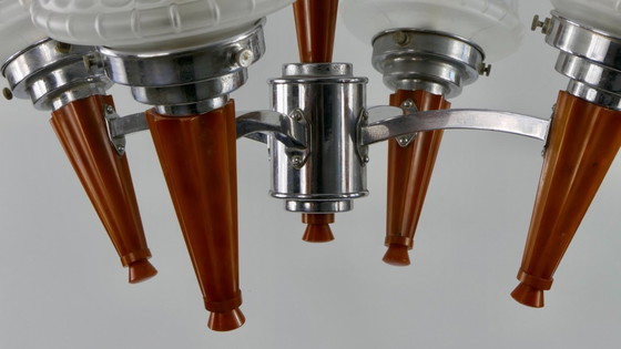 Image 1 of Chrome Art Deco chandelier with four amber Bakelite torches with decorated glass lampshades, ca. 1935
