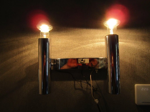 This chrome-colored space-age wall lamp is attributed to designer Gaetano Sciolari from the 1970s.