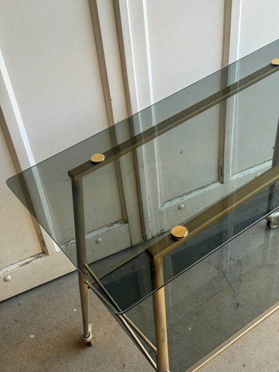 Image 1 of Carrello di servizio a due livelli in vetro fumé e metallo dorato