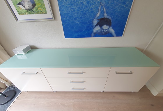 Image 1 of White modern sideboard with a separate glass top. Heavy-duty quality.