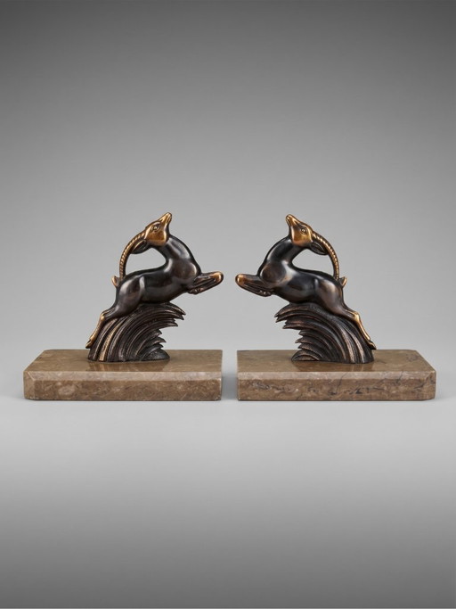 Serre-livres Art Déco en régule patiné – paire animalière stylisée – socles en marbre taupe – années 1930